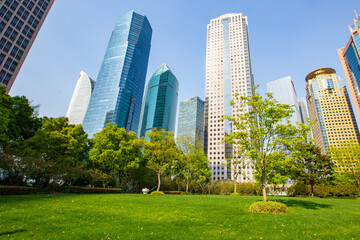Obraz premium Central Park in Lujiazui, a big lawn in front of the modern skyscrapers.