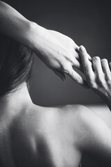 Black and white image of a girl with hands from the back.