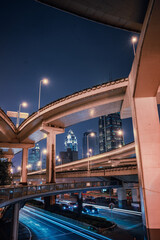 nNight view of the traffic under a overpass bridge in Shanghai, China.