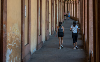 Mother and daughter running for exercise in portico