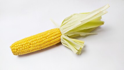Close up fresh yellow sweet corn isolated on white background