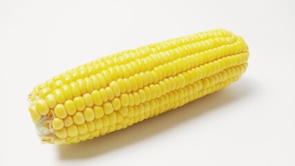 Close up fresh yellow sweet corn isolated on white background