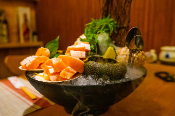 Vietnamese - Asian people eating sashimi set in Japanese restaurant. Hirame sashimi,salmon sashimi and tuna sashimi dish.