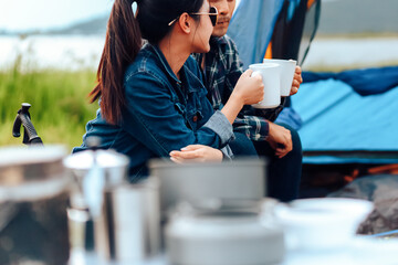 Couples drink coffee together during the morning camping.