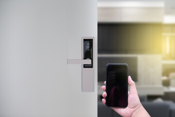 Hotel door security Unlocking by application on mobile phone. Digital door lock, key less system of access door. Close up and selective focus.
