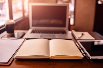Office workplace with laptop, calculator, book and document on wood table