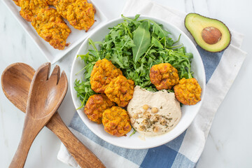 healthy superbowl or Buddha bowl with salad, baked sweet potatoes