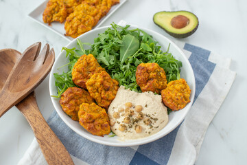 healthy superbowl or Buddha bowl with salad, baked sweet potatoes
