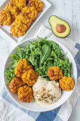 healthy superbowl or Buddha bowl with salad, baked sweet potatoes