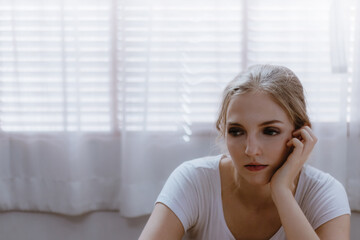 Portrait of young stressed Caucasian woman in sad emotion at home