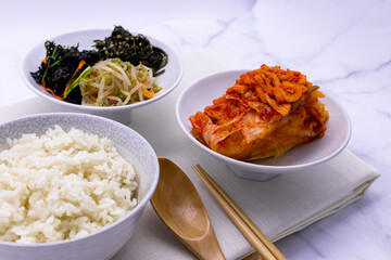 Korean food with rice, kimchi, side dishes.