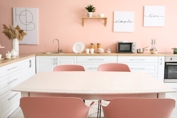 Dining table in interior of modern kitchen