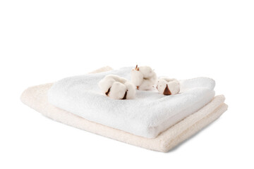 Cotton flowers and soft towels on white background