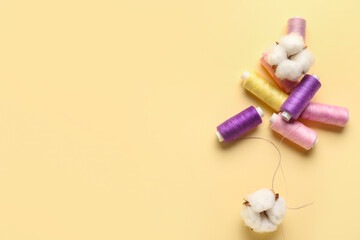Cotton flowers and threads on color background