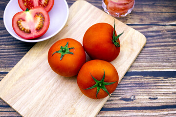 Fresh tomatoes on a wooden table