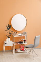 Rack with decorative cosmetics and mirror in modern makeup room