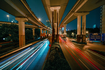 Fototapeta na wymiar nNight view of the traffic under a overpass bridge in Shanghai, China.
