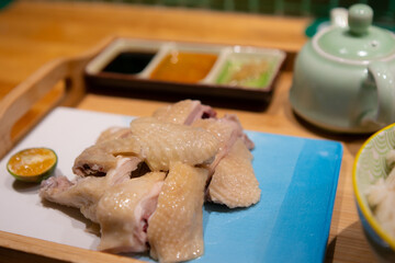 Hainanese Chicken Rice, a traditional cantonese dish with fresh boiled chicken and specially steamed rice.