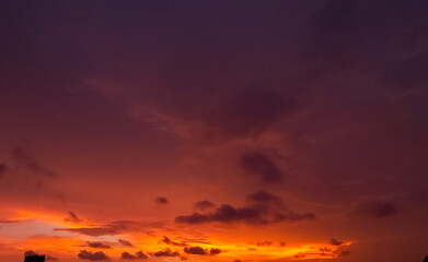 The high sunlit clouds drifted across a clear blue sky. The sky above was full of tumultuous, dark, ragged clouds. As the sun set, the few thin strips of clouds on the horizon turned shimmering gold