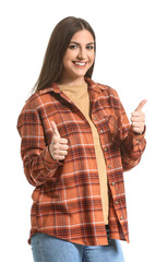 Young woman showing thumb-up gesture on white background