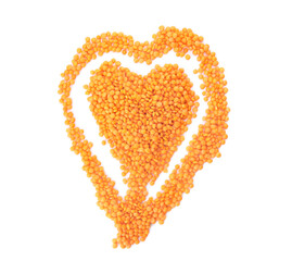 Heart made of red lentils on white background