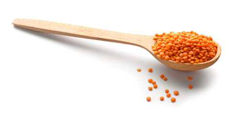 Spoon with red lentils on white background
