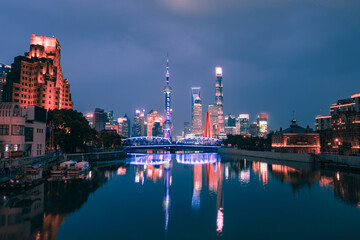 Fototapeta na wymiar Night view of Waibaidu Bridge and Lujiazui, the skyline and landmark in Shanghai, China, with reflection in front.