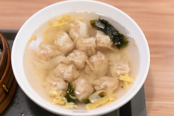 Wonton soup, Chinese traditional food with boiled meat filled wonton and seaweed soup.