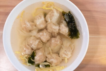 Wonton soup, Chinese traditional food with boiled meat filled wonton and seaweed soup.