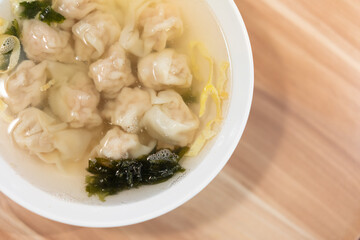 Wonton soup, Chinese traditional food with boiled meat filled wonton and seaweed soup.