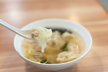 Wonton soup, Chinese traditional food with boiled meat filled wonton and seaweed soup.