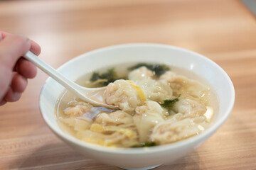 Wonton soup, Chinese traditional food with boiled meat filled wonton and seaweed soup.