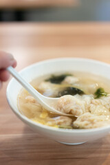 Wonton soup, Chinese traditional food with boiled meat filled wonton and seaweed soup.