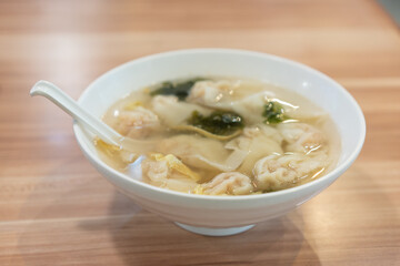 Wonton soup, Chinese traditional food with boiled meat filled wonton and seaweed soup.