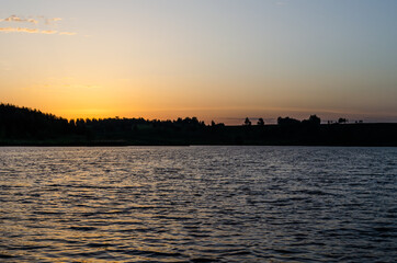 Naklejka premium Sunrise over the lake. Summer dawn