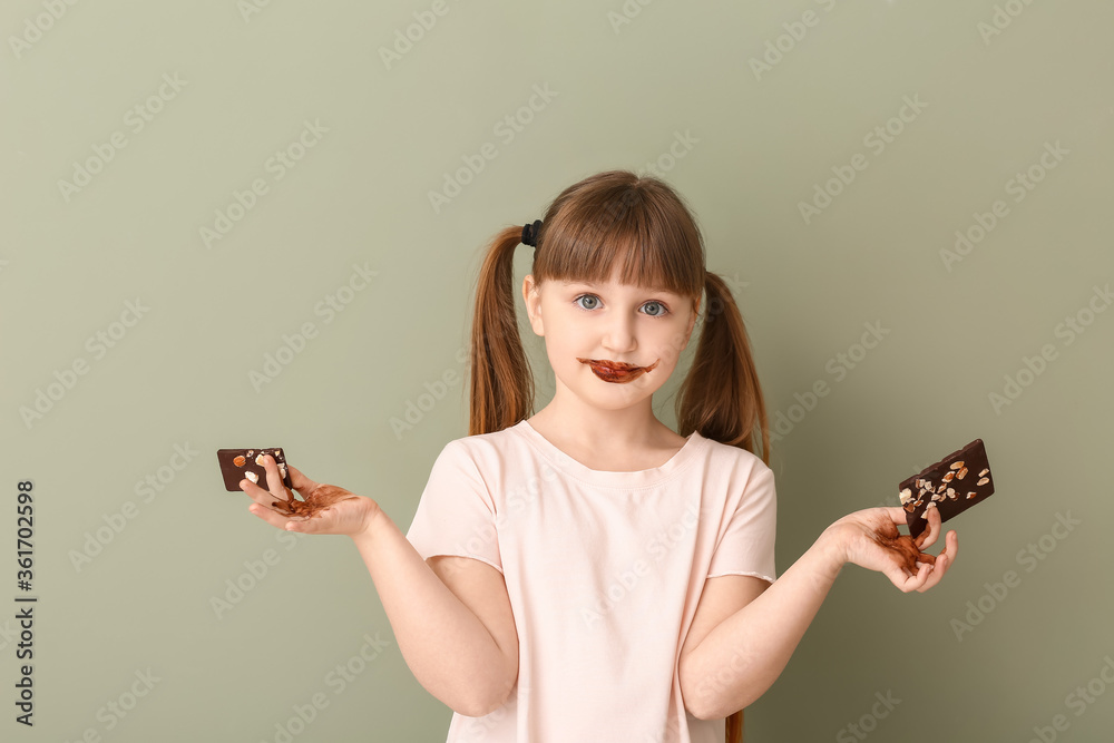 Wall mural Cute funny girl with chocolate on color background