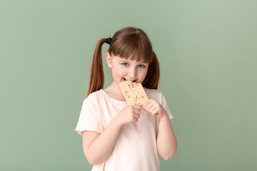 Cute funny girl with chocolate on color background