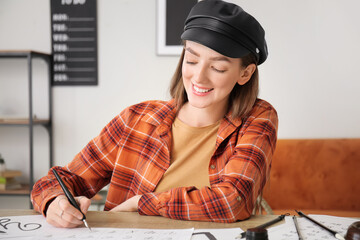 Female calligraphist working in office