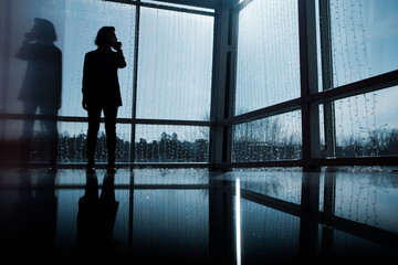 Fototapeta na wymiar Photo business woman talking smartphone and holding documents in hands. Open space loft office. Panoramic windows background. Horizontal mockup. Film effect.