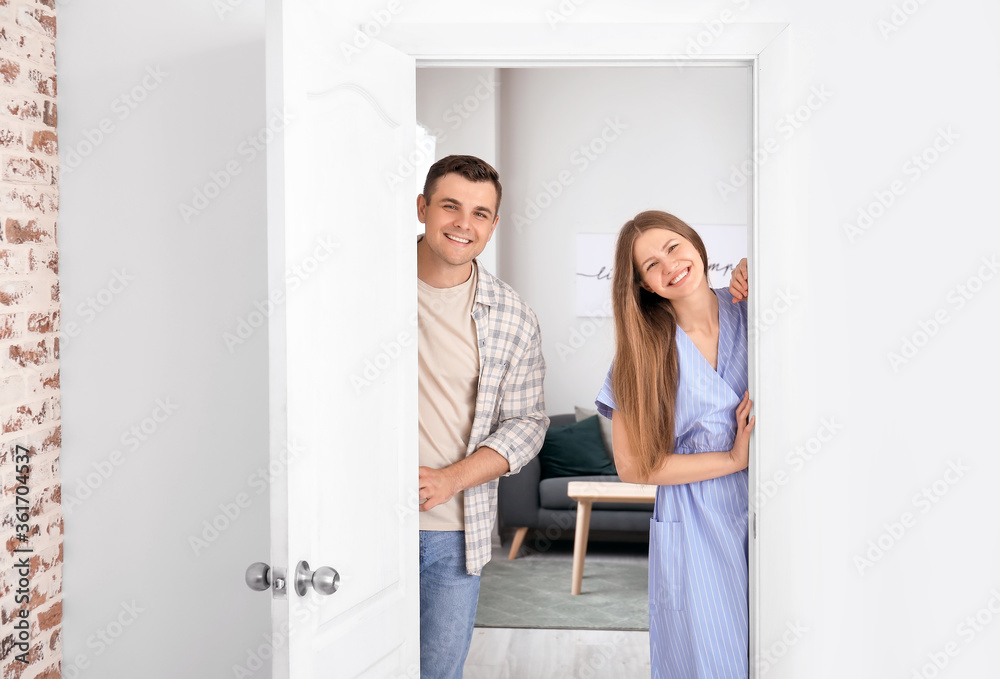 Canvas Prints Happy couple standing in doorway at their new home