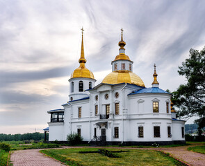 Fototapeta na wymiar Ust-Kuda, Russia - 24 June 2020: Russian rural landscape with Church of Kazan icon of mother of God