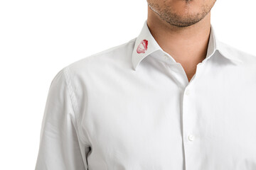 Young businessman with lips print on shirt collar against white background, closeup