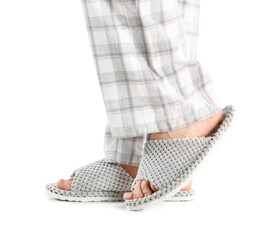 Female legs in soft slippers on white background