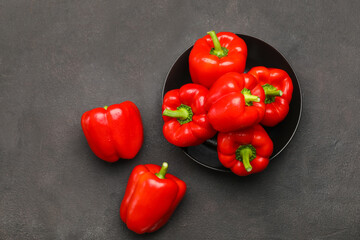Bowl with red bell pepper on dark background