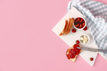 Board with tasty strawberry jam, bread and butter on color background