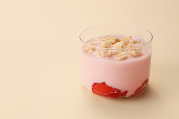 Glass of healthy strawberry yogurt on color background