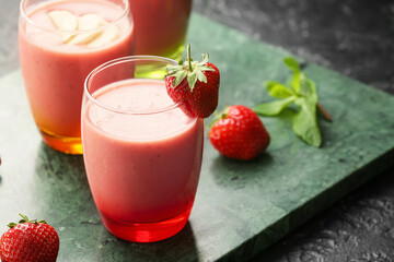 Glasses of tasty strawberry smoothie on table