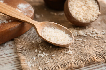 Spoon with rice on table