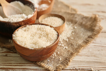 Bowl with rice and flour on table