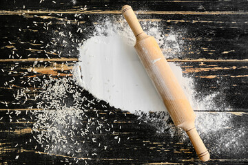 Rice flour with rolling pin on table